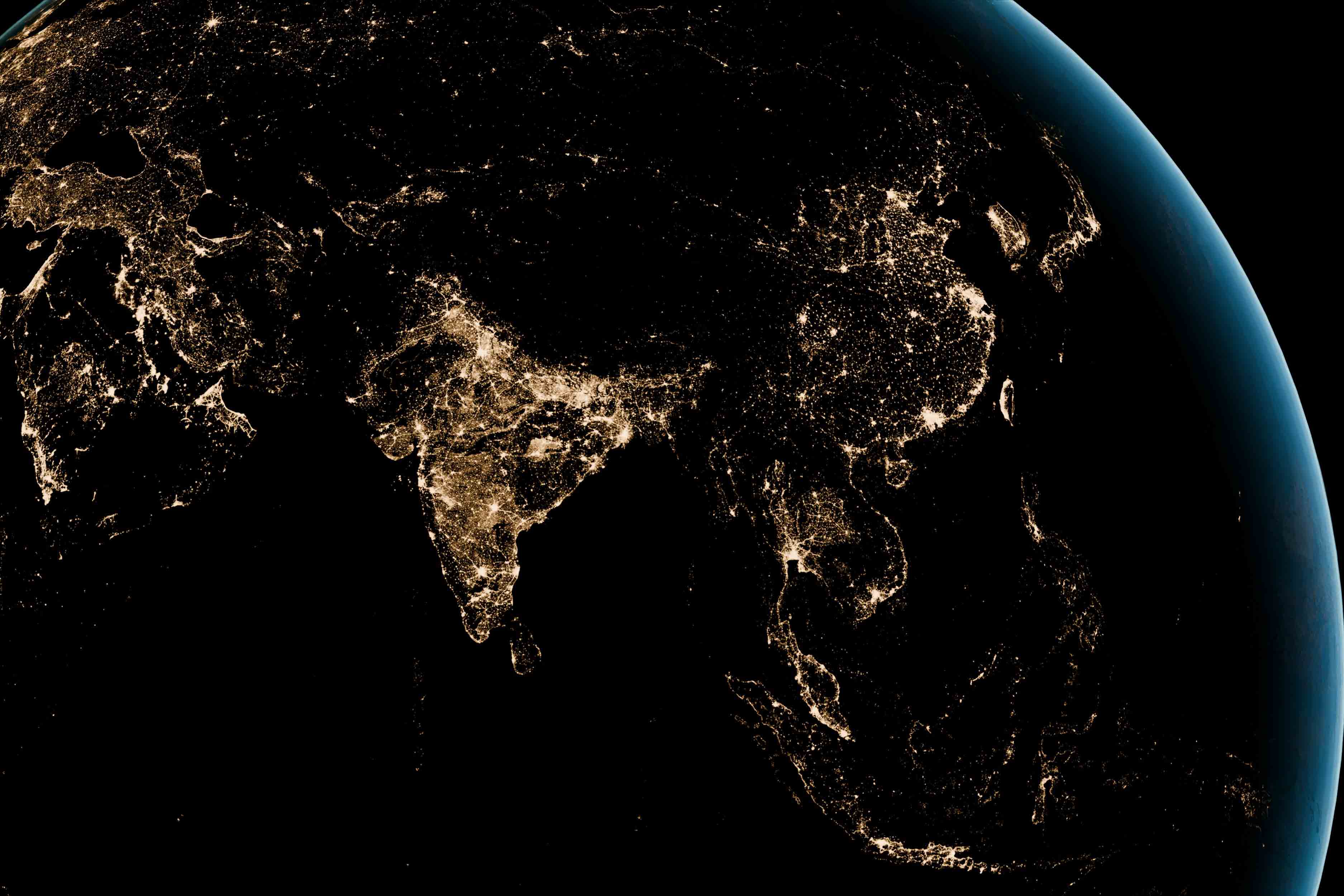 Satellite view of South Asia and Southeast Asia at night showing city lights illuminating countries including India, China, and surrounding regions.